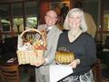 Sharon Butler and Michael LoMonaco are happy they bid on the arrangement that included the beautiful glass pumpkins generously donated by Alain Pinel Realtors.