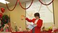 Auction Chair Carolyn Miller entices members to bid on this sweet treat.