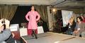 SILVAR member Fe Manzano of Keller Williams Realty in Cupertino models a winter coat and boots at the FAREPA fashion show.