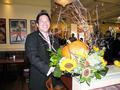 Ryan Iwanaga of Sereno Group bought Laura Peterson's bundt cake and this beautiful arrangement donated by Old Republic Title.