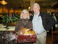 Sharon Butler and Neil Reid proudly pose by their purchase, the big prize of the event - glass pumpkins donated by Intero Real Estate Services.
