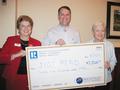 Charitable Foundation Trustee Joanne Fraser and Los Altos/Mountain View District Chair Bryan Robertson are pictured here with Molly McCrory, president of Just READ.