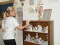 Janna Kolodi begins dusting the furniture.