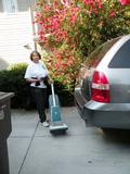 Olivia Gray takes out the vacuum cleaner from the car.