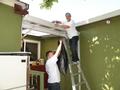 Here are Perry Wong and Thomas Feng busy cleaning gutters.