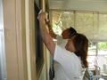 Tess Crescini and Richard Martinez wash windows for an 82-year-old Sunnyvale senior homeowner.