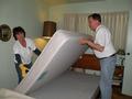 Diane Renna and Tom Cooper flip the mattress for a 91-year-old Sunnyvale senior homeowner.
