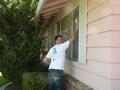 Joe Velasco washing windows at a Los Altos home.