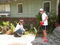 Nancy Hobson and Lorie Satzger (right) tackle weeds at the home of a Palo Alto elderly lady.