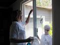 Laurie Ramirez and Barbara Kubert wash windows for a Cupertino homeowner.