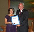 Carolyn Miller accepts a commendation from State Assembly Member Paul Fong.