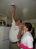 Tom Anderson and Lisa Wittkopf replace lightbulbs for a Palo Alto homeowner.