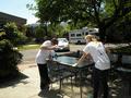 RSVP volunteers wash an outdoor table.
