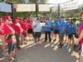 The umpire spells out the rules of the game to both teams.