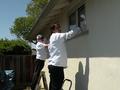 RSVP volunteers Richard Miller and Ali Alamdar clean windows for a Sunnyvale senior homeowner.