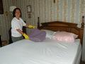 Miranda Jung gets ready to make the senior's bed after the volunteers flipped her mattress.