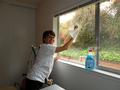 Grace Garland begins washing the inside windows for the homeowner.