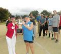 Team 650 Coordinator Lehua Greenman hands the trophy to Team 408 team Captain Suzanne Yost.