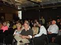 Members trickle in and get comfortable before the start of the meeting.