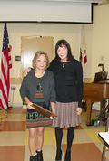 Past district chair Sara Spang presented Sunny Dykwel with the Community Outreach award.