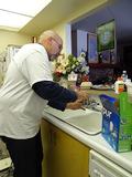 Dennis Bower replaces a filter for a 75-year-old Los Altos senior.