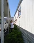 Dian Bowens washes an outside window.