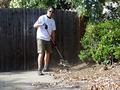 First-time volunteer Bert Oey rakes leaves for a Saratoga senior.