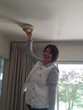 Rebecca Johnson replaces a smoke detector battery for a Menlo Park senior.