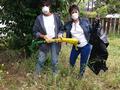 Diane Rothe and Lehua Greenman whacking weeds for a Menlo Park senior.