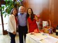 Davena Gentry and Bonnie Kehl (right) persuade Bill Moody to buy some raffle tickets.