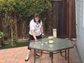 Cindy Legacy cleans a senior homeowner's patio furniture.