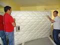 Bert Oey and Frank Quinn flip a mattress for a Saratoga homeowner.