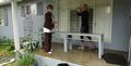 Leslie Melmon and Susan Ward wash windows.