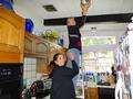 In Menlo Park, Sia Glafkides and Carolyn Rianda changed light bulbs for a senior homeowner.