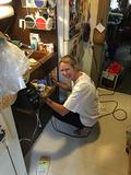 Julie Ray cleans a desk.