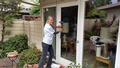 Maria Quinby washes a patio door and windows for a Palo Alto senior.