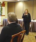 District Chair Katherine Frey greets members at this morning's breakfast.