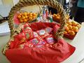 Celebrating the Lunar New Year with red envelopes and round fruits.