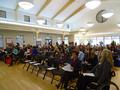 People take their seats as the program is ready to begin.