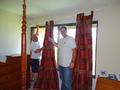 Kraig Constantino helps Kevin Barrett hang a bedroom curtain. An RSVP volunteer for the last five years, Constantino said the volunteers need him for his height!