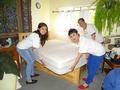 Piya Wan, Lehua Greenman and Jimmy Kang flip a mattress for a Menlo Park senior homeowner.