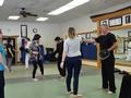 REALTORS® practice the self-defense techniques with the instructors.