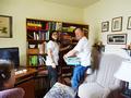 Dave Barca and Pamela Ghandour help empty a bookcase for a senior homeowner.