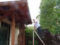 Jeff Beltramo checks the gutters of a homeowner.