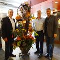 Mark Von Kaenel, Shawn Carroll and Jim Myrick pose beside the Coldwell Banker display.
