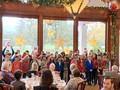 Members thoroughly enjoyed singing by students from St. Simon Parish School.