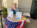 Caroline Wolf reminded everyone who stopped by to put a card in the jar for the drawings of prizes.