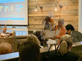 Suzanne Yost shows off another beautiful packaged auction item which contains many prizes.