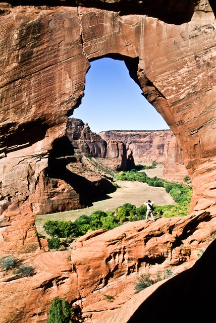 Vista beneath natural bridge in rock wall, Canyon del Muerto, Arizona