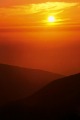 Sun drops low beyond Big Sur ridges, Big Sur, California